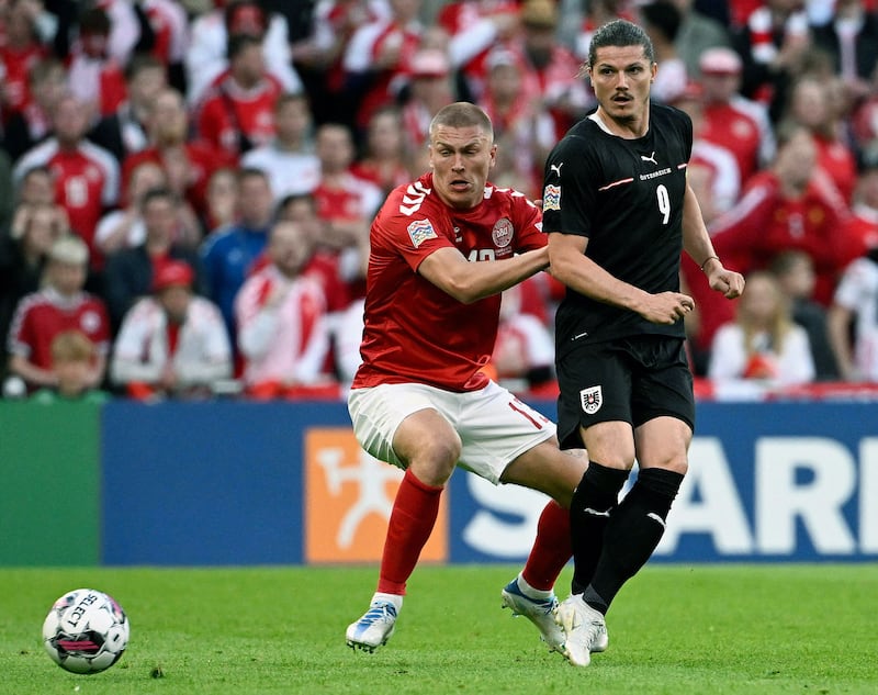 Denmark defender Rasmus Kristensen (l) and Austria's Marcel Sabitzer battle for the ball during their Nations League meeting on June 13, 2022. AFP