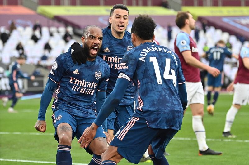 Arsenal's Alexandre Lacazette celebrates with teammates after scoring the third goal against West Ham on Sunday. EPA