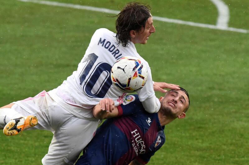 Real Madrid midfielder Luka Modric battles for possession with Huesca's Pablo Maffeo. EPA