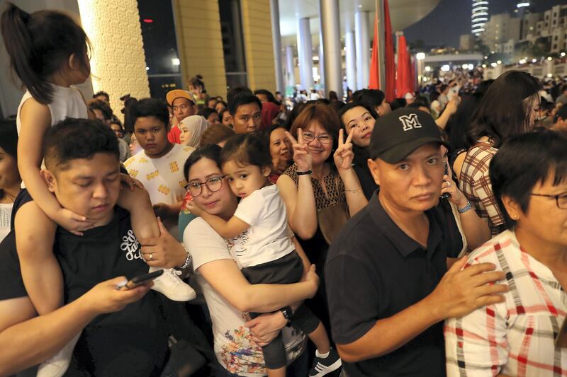 DUBAI ,  UNITED ARAB EMIRATES , JUNE 12 – 2019 :- People gathered to see Burj Khalifa which will be displaying a projection of the Philippines flag for the first time ever in commemoration of Philippines National Day at Dubai Mall in Dubai. ( Pawan Singh / The National ) For News