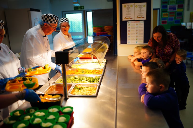 First Minister of Wales Mark Drakeford serves lunches during a visit to a school, to begin the roll-out of free school meals for primary school children, in Pembrokeshire, on September 7. PA