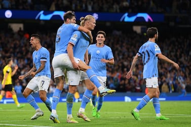 MANCHESTER, ENGLAND - SEPTEMBER 14: Erling Haaland of Manchester City celebrates with team mate John Stones after scoring their sides second goal during the UEFA Champions League group G match between Manchester City and Borussia Dortmund at Etihad Stadium on September 14, 2022 in Manchester, England. (Photo by Michael Regan / Getty Images)