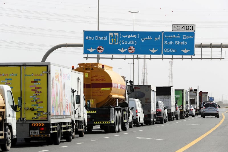 DUBAI, UNITED ARAB EMIRATES , June 2 – 2020 :- Traffic jam at the Dubai border going towards Abu Dhabi on Sheikh Zayed road in Dubai. Abu Dhabi Police checking the movement permits at the police checkpoint on the Dubai – Abu Dhabi border on Sheikh Zayed road in Dubai. Abu Dhabi impose one week ban starting from Tuesday on travel on entering and leaving the emirate to reduce the spread of Covid-19  and ensure its huge testing drive works. (Pawan Singh / The National) For News/Online 