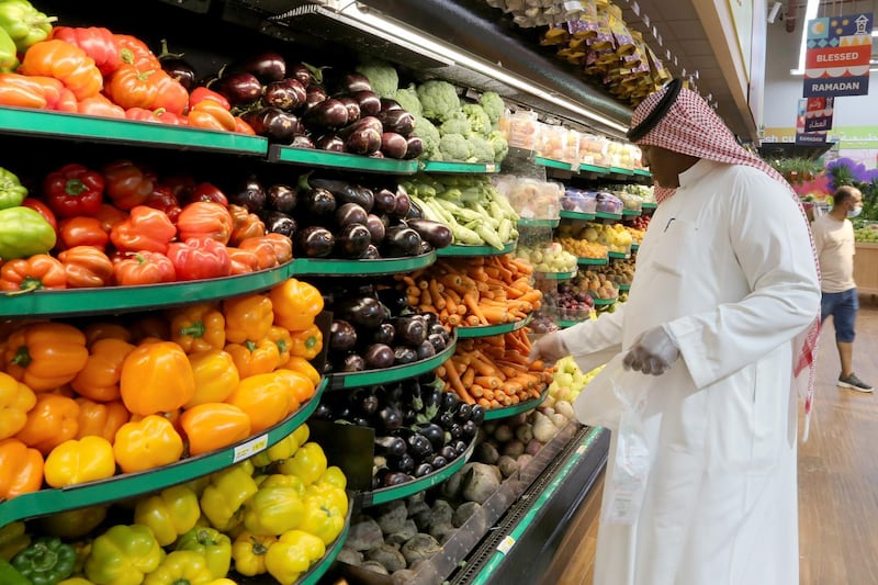 A Saudi man wearing protective gloves buys vegetables at a supermarket in Riyadh, Saudi Arabia. Reuters