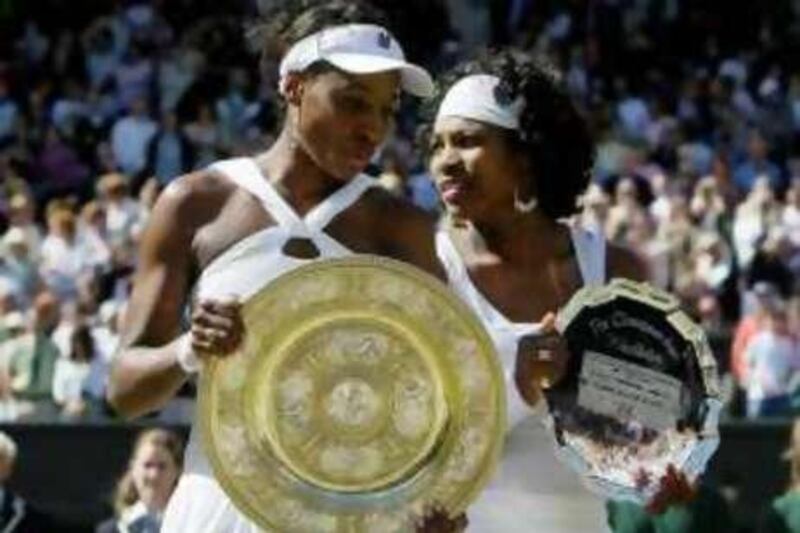 Venus Williams left, of the US holds her trophy after winning the women's singles final against her sister Serena right, on the Centre Court at Wimbledon, Saturday, July 5 , 2008. (AP Photo/Anja Niedringhaus) *** Local Caption ***  XWIM183_Britain_Wimbledon_Tennis.jpg