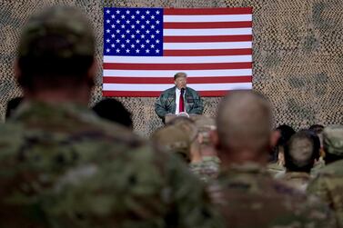 US President Donald Trump speaks to members of the military at a hangar rally at Al Asad Air Base, Iraq, on December 28, 2018. AP 