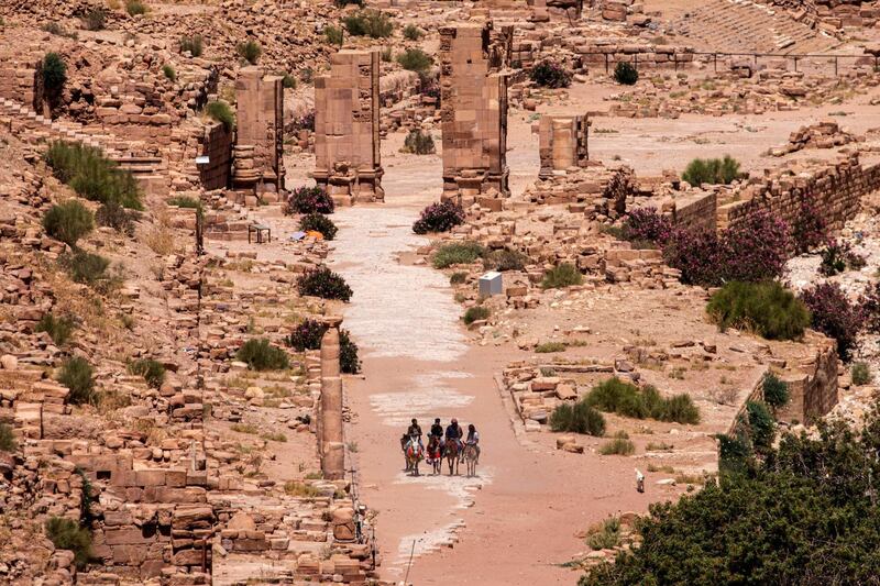 Domestic tourists ride donkeys as they visit the reopened Petra archeological site. EPA