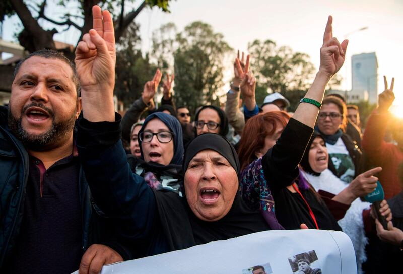 Supporters of Morocco's al-Hirak al-Shaabi movement hold placards and shout slogans calling for the release of the movement's members outside the Casablanca.  AFP