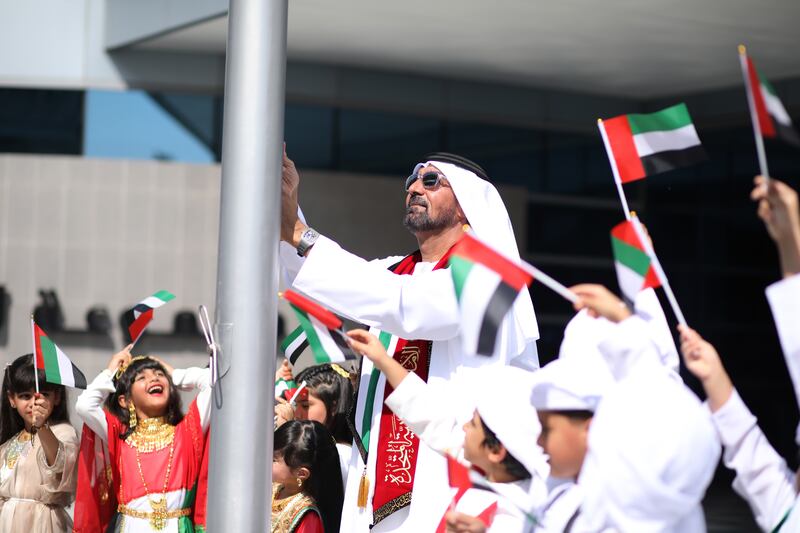 Sheikh Ahmed bin Saeed, chairman and chief executive of Emirates Group, raises the UAE Flag at the group's headquarters. Photo: Emirates