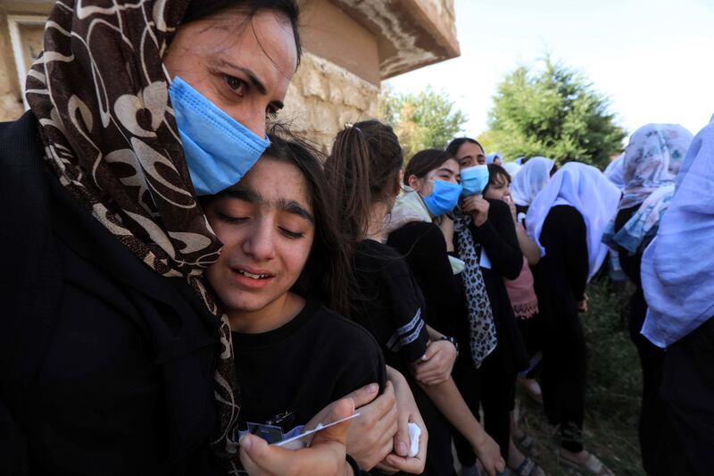 An Iraqi Yazidi woman comforts a grieving youngster during the funeral of Baba Sheikh Khurto Hajji Ismail (image), supreme spiritual leader of the Yazidi religious minority, in the Iraqi town of Sheikhan, 50km northeast of Mosul, on October 2, 2020. - Iraq's Yazidi minority laid to rest their spiritual leader today as tributes poured in for the man who guided his flock through the horrors of Islamic State group occupation.
Baba Sheikh Khurto Hajji Ismail died late yesterday at the age of 87, his office said. (Photo by SAFIN HAMED / AFP)