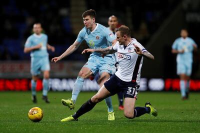 Soccer Football - Championship - Bolton Wanderers vs Sunderland - Macron Stadium, Bolton, Britain - February 20, 2018   Sunderland's Paddy McNair in action with Bolton Wanderers' David Wheater   Action Images/Lee Smith    EDITORIAL USE ONLY. No use with unauthorized audio, video, data, fixture lists, club/league logos or "live" services. Online in-match use limited to 75 images, no video emulation. No use in betting, games or single club/league/player publications. Please contact your account representative for further details.