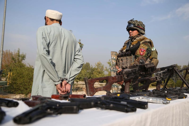 epa07216278 Afghan security officials show a suspected militant who was arrested during an operation by the Afghan Border Police, in Jalalabad, Afghanistan, 08 December 2018. Violence in many parts of Afghanistan has surged in recent months even as the United States has had a series of talks with the Taliban.  EPA/GHULAMULLAH HABIBI