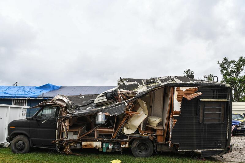 Debris of a van damaged by Hurricane Laura less than 6 weeks ago is seen on the street in Lake Charles, Louisiana on October 8, 2020, a day before Hurricane Delta was expected to hit the southern US state. AFP