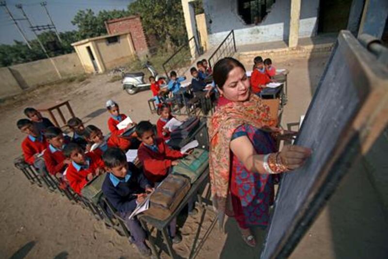 Indian school children attend a class in the open at a government school in the outskirts of Jammu, India, Thursday, Dec.2, 2010.Indian technology mogul Azim Premji has announced he will donate nearly $2 billion to fund education and development programs in India's villages in one of the largest charitable donations in the country's history.(AP Photo/Channi Anand)