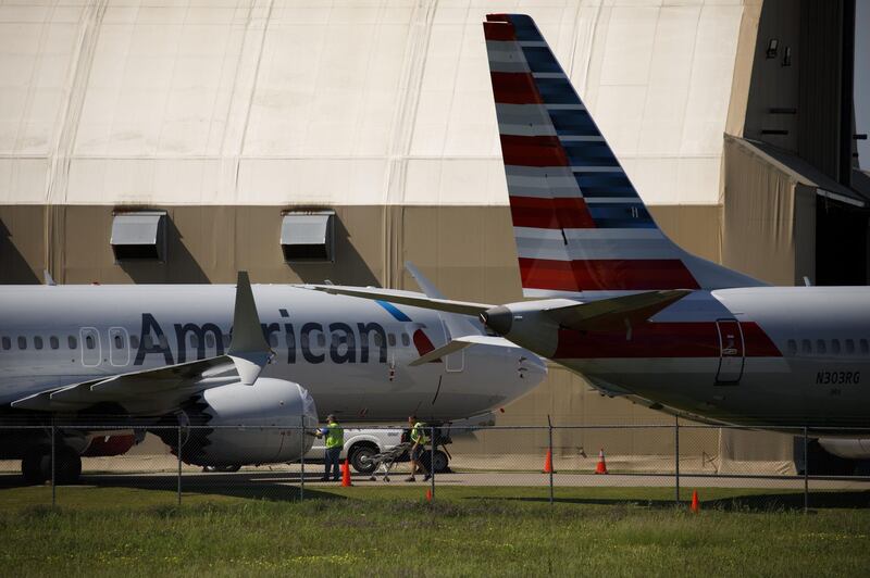 Maintenance workers cover the engine of an American Airlines Group Inc. Boeing Co. 737 Max plane outside of a maintenance hangar at Tulsa International Airport (TUL) in Tulsa, Oklahoma, U.S., on Tuesday, May 14, 2019. Three unions representing aviation safety inspectors said in a sharply worded report months before the Boeing's 737 Max was approved for use that the planemaker was given too much authority to oversee itself and that the new jet had safety flaws. Photographer: Patrick T. Fallon/Bloomberg
