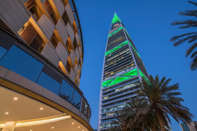 The Al Faisaliah Tower lit up in the green of Saudi Arabia. The tower can project lightshows into the night sky