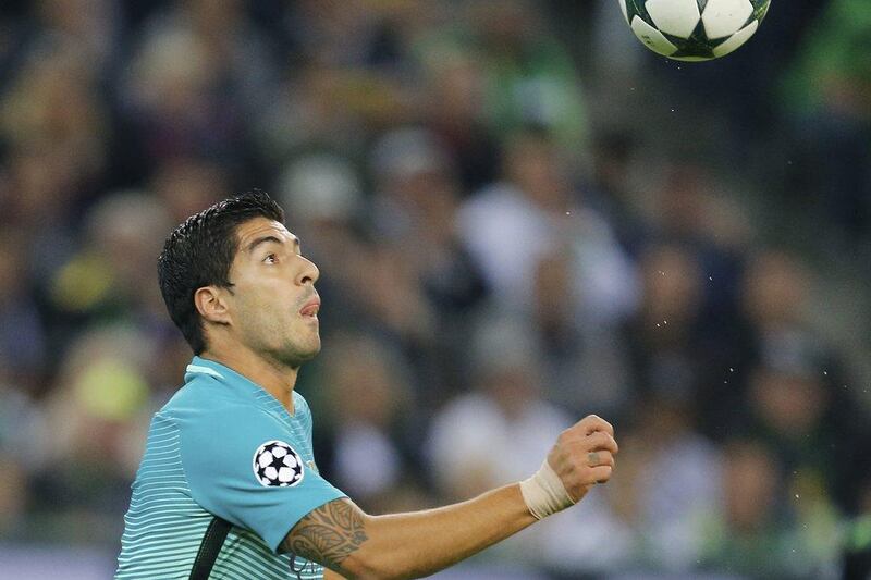 Barcelona’s Luis Suarez eyes the ball during the Champions League match against Borussia Monchengladbach. Michael Probst / AP Photo