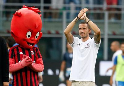 FILE - In this photo taken on Aug. 3, 2017, former Juventus player Leonardo Bonucci waves to his new fans, prior to the start of an Europa League third qualifying round, second leg, soccer match at the San Siro stadium in Milan, Italy. After a tumultuous two months, and in spite of loosing one of its key defenders who was sold to AC Milan, Juventus is looking to get back to what it does best: winning trophies. (AP Photo/Antonio Calanni)