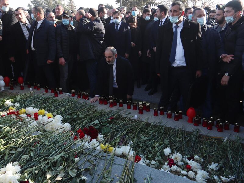 epa08893474 Armenian Prime Minister Nikol Pashinyan (C) during his visit to the Yerablur military pantheon, the burial place of Armenian soldiers who were killed during the Nagorno-Karabakh conflict, in the outskirts of Yerevan, Armenia, on the first day of the nationwide mourning 19 December 2020. Armenian Prime Minister Nikol Pashinyan declared a 3-day nationwide mourning period starting on December 19  for people who had been killed in the latest armed conflict between Azerbaijan and Armenia over the Nagorno-Karabakh territory along the contact line of the self-proclaimed Nagorno-Karabakh Republic (also known as Artsakh).  EPA/VAHRAM BAGHDASARYAN / PHOTOLURE MANDATORY CREDIT