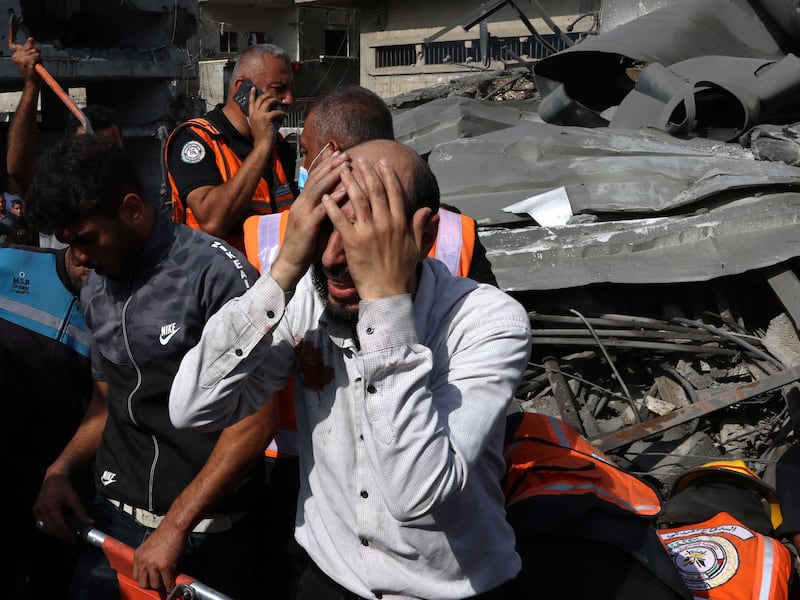 A Palestinian cries as the body of his daughter is recovered from beneath the rubble of a building destroyed during an Israeli air strike on Rafah. AFP