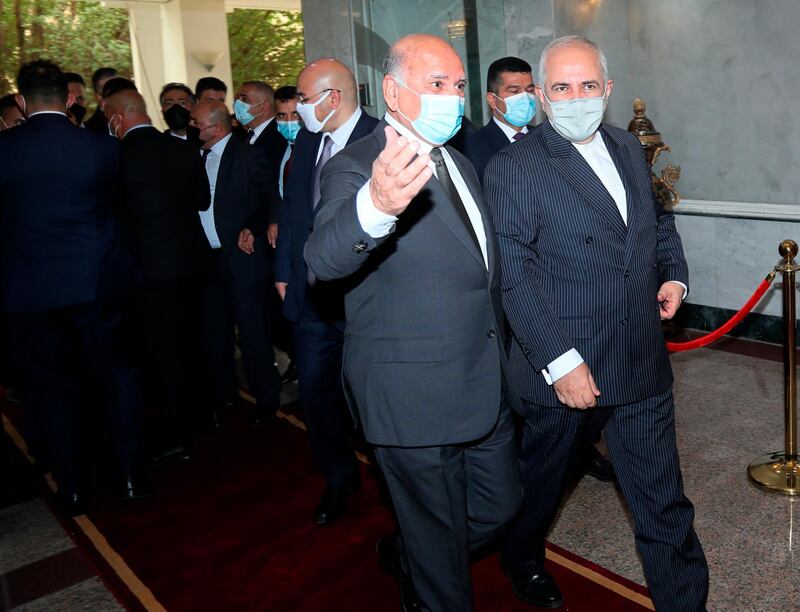 Mr Zarif, right, meets Iraqi Foreign Minister Fuad Hussein in Baghdad. AP