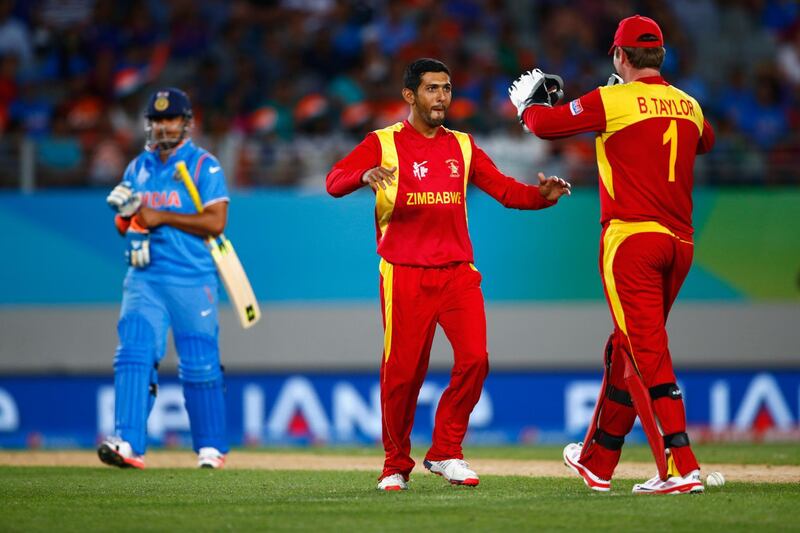 AUCKLAND, NEW ZEALAND - MARCH 14:  Sikandar Raza of Zimbabwe celebrates bowling Virat Kohli of India during the 2015 ICC Cricket World Cup match between India and Zimbabwe at Eden Park on March 14, 2015 in Auckland, New Zealand.  (Photo by Phil Walter/Getty Images)