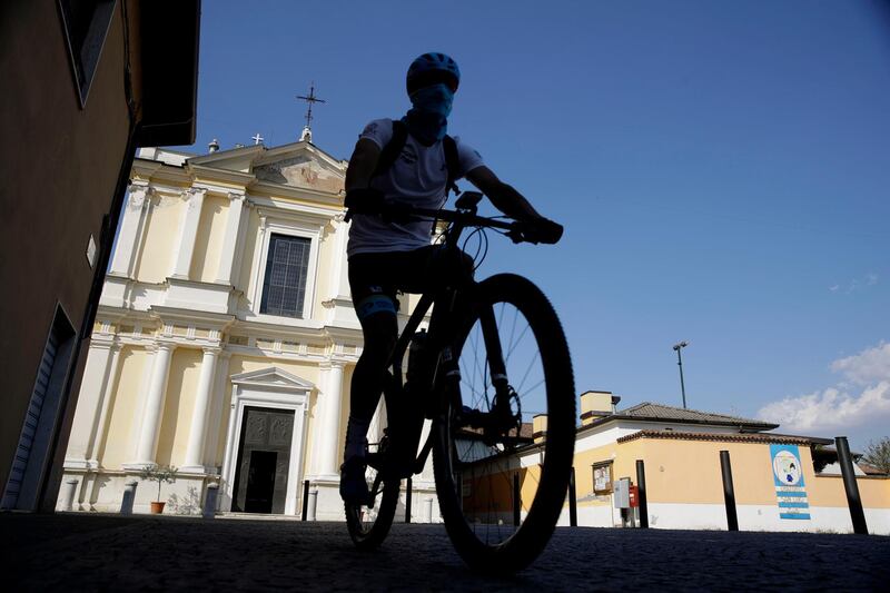 Davide Martinelli rides his bike as he delivers medicine to residents in Lodetto, near Brescia, Northern Italy. AP Photo