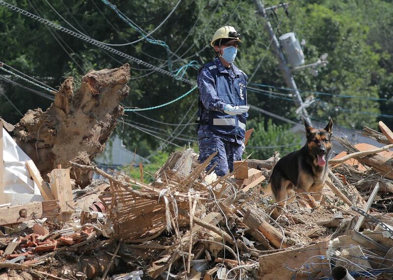 A member of Maritime Self Defense Forces searches for missing persons at a flood damage site in Kure, Hiroshima prefecture on July 12, 2018.  AFP