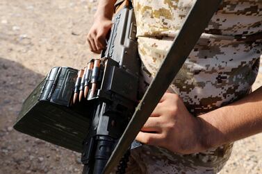 A member of Libya's internationally recognised government forces carries a weapon in Ain Zara, Tripoli. Reuters