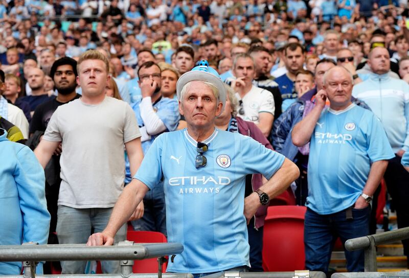 Manchester City fans look dejected. PA