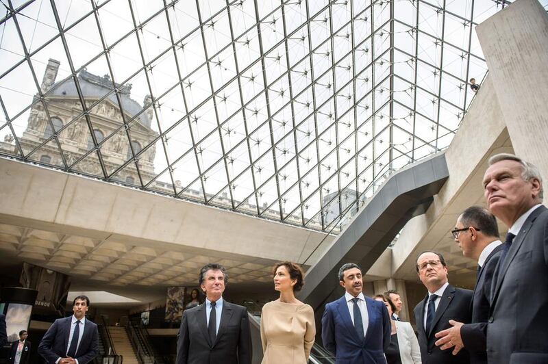 From right: French foreign minister Jean-Marc Ayrault, head of the Louvre museum Jean-Luc Martinez, French president Francois Hollande, Sheikh Abdullah bin Zayed, French culture minister Audrey Azoulay and former French culture minister Jack Lang at the Louvre museum. Christophe Petit Tesson / AFP