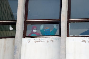 Nurses look out from a hospital window in Yemen's capital Sanaa, which is occupied by Houthi rebels. Covid-19 data for Houthi-held areas is unavailable. EPA