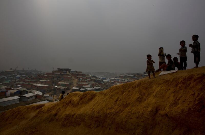 Rohingya refugee children play on a mud mount at Balukhali refugee camp 50 kilometres (32 miles) from, Cox's Bazar, Bangladesh, Monday, Jan. 15, 2018. Myanmar officials say a camp to house Rohingya Muslim and Hindu refugees who return from Bangladesh will be ready by its promised deadline next week. Myanmar and Bangladesh are discussing the logistics of how many Rohingya will be allowed into Myanmar and how they will be scrutinized to be placed in the camps. Hundreds of thousands of Rohingya have fled violence that has been described as ethnic cleansing. Observers doubt Rohingya will return to Myanmar willing unless their safety is guaranteed.(AP Photo/Manish Swarup)