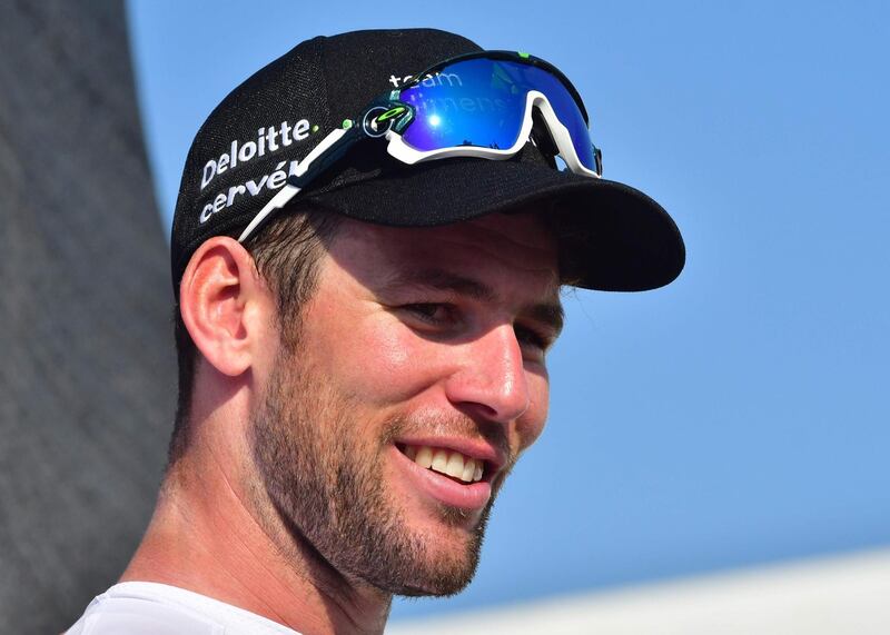 Dimension Data's British rider Mark Cavendish smiles on the podium after his victory in the third stage of the Dubai Tour, from Sky Dive Dubai to Fujairah on February 8, 2018. / AFP PHOTO / GIUSEPPE CACACE