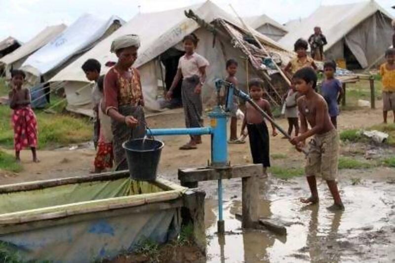 A Muslim boy fetches water from a pump inside a refugee camp in Sittwe, Rakhine state, western Myanmar.