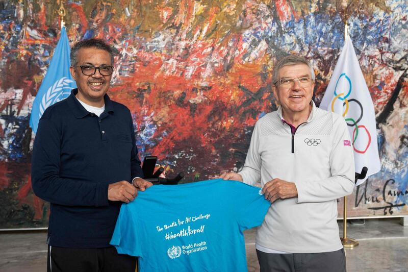 This handout provided by the World Health Organization (WHO) shows WHO Director-General Tedros Adhanom Ghebreyesus (L) presenting a t-shirt to International Olympic Committee (IOC) President Thomas Bach prior to signing a cooperation agreement on promoting healthy society through sport and on contributing to the prevention of non-communicable diseases on May 16, 2020 at the WHO headquarters in Geneva. Olympic chief Thomas Bach called for vigilance and patience in preparations for the Tokyo Summer Games, postponed a year until 2021 because of the coronavirus pandemic. - RESTRICTED TO EDITORIAL USE - MANDATORY CREDIT "AFP PHOTO / World Health Organization / Christopher Black" - NO MARKETING NO ADVERTISING CAMPAIGNS - DISTRIBUTED AS A SERVICE TO CLIENTS


 / AFP / World Health Organization / Christopher Black / RESTRICTED TO EDITORIAL USE - MANDATORY CREDIT "AFP PHOTO / World Health Organization / Christopher Black" - NO MARKETING NO ADVERTISING CAMPAIGNS - DISTRIBUTED AS A SERVICE TO CLIENTS


