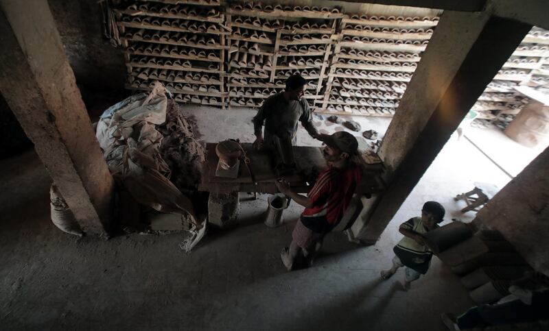 An Egyptian worker shapes a clay ornament at one of the traditional pottery workshops, in old Cairo, Egypt.