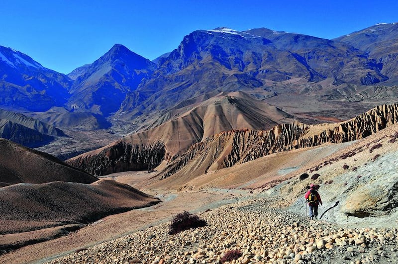 A solo trekker walks through remote peaks of Mustang, Nepal. Getty Images