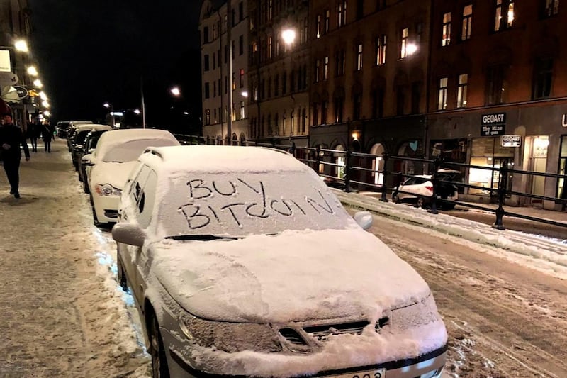 A car with a sign "Buy Bitcoin" written in snow is pictured in Stockholm, Sweden January 16, 2021. Picture taken January 16, 2021. REUTERS/Colm Fulton NO RESALES. NO ARCHIVES