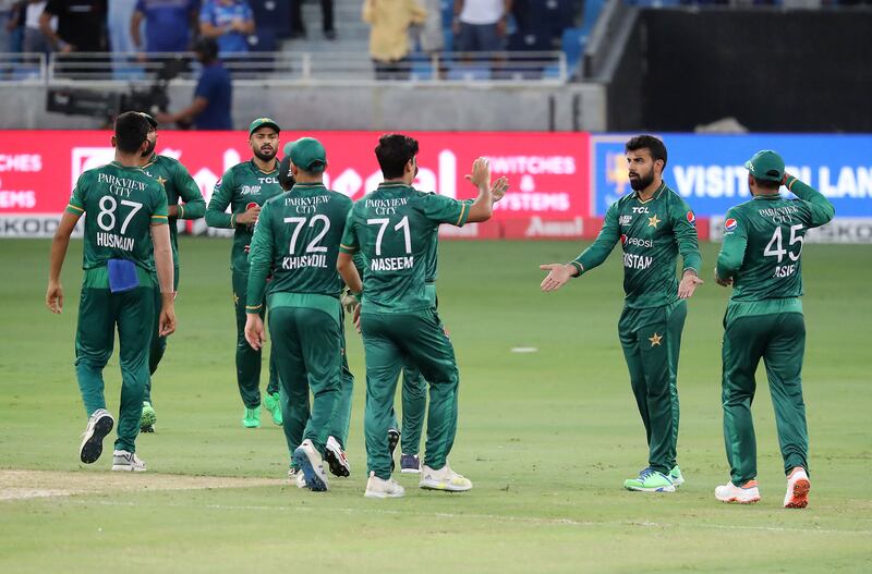 Shadab Khan, second from right, celebrates after taking the wicket of KL Rahul. Pawan Singh / The National
