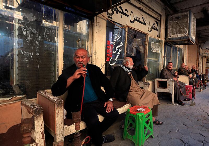 Patrons sit outside the Hassan Ajami cafe in al-Rasheed street, the oldest street in Baghdad, Iraq. AP