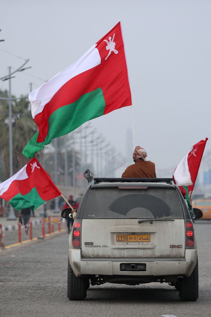 A supporter waves the flag of Oman, from a car in Iraq's southern city of Basra, on January 16, before the Arabian Gulf Cup semi-final football match between Bahrain and Oman. AFP

