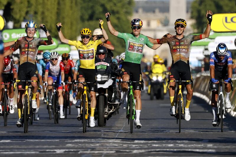 Jumbo Visma riders Tiesj Benootthe, Jonas Vingegaard, Wout Van Aert and Christophe Laporte celebrate as they cross the finish line. EPA