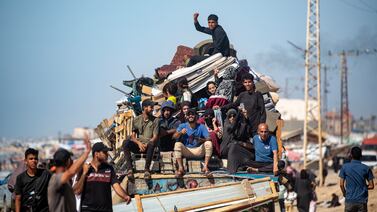 Internally displaced Palestinians leave with their belongings following an evacuation order issued by the Israeli army, in Rafah. EPA