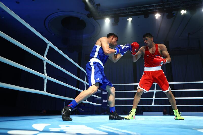 Jafarov Saidjamshid of Uzbekistan (red) waits to parry jabs from Sulaiman of Afghanistan (blue) in the men's middleweight 75kg preliminary bout on day one of the Asian Boxing Championships. Getty Images