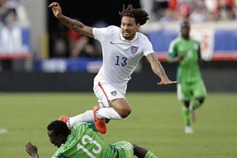 Jermaine Jones, in white, of the United States is tripped up by defender Juwon Oshaniwa of Nigeria during their friendly in Jacksonville. Mike Zarrilli / Getty Images