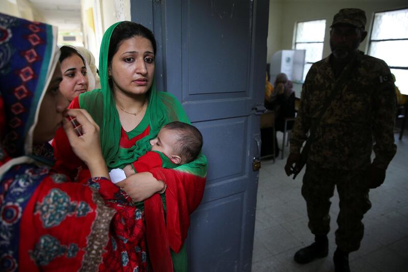 Voters wait to enter a polling station in Islamabad. Reuters