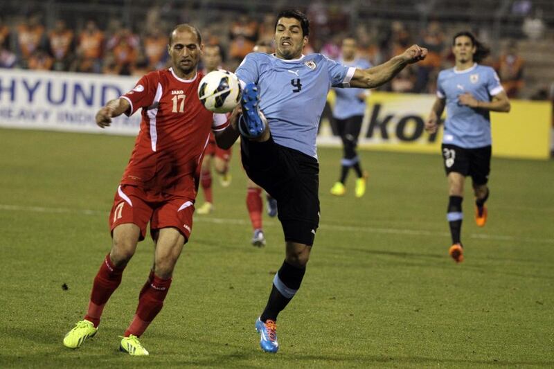 Luis Suarez, centre, and Uruguay are well on their way to the 2014 World Cup after a comprehensive 5-0 victory in Jordan. Khalil Mazraawi / AFP