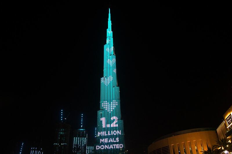 The Burj Khalifa, the world's tallest building, displays a message as part of the "World's Tallest Donation Box" campaign in Dubai, United Arab Emirates, Monday, May 11, 2020. The campaign raised money for meals to the hungry amid the coronavirus pandemic. (AP Photo/Jon Gambrell)