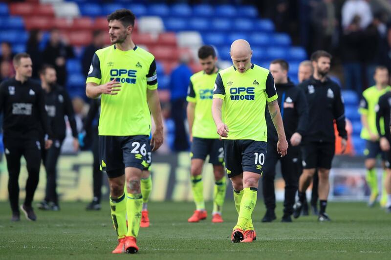 Huddersfield Town players look dejected as they leave the pitch. Getty Images